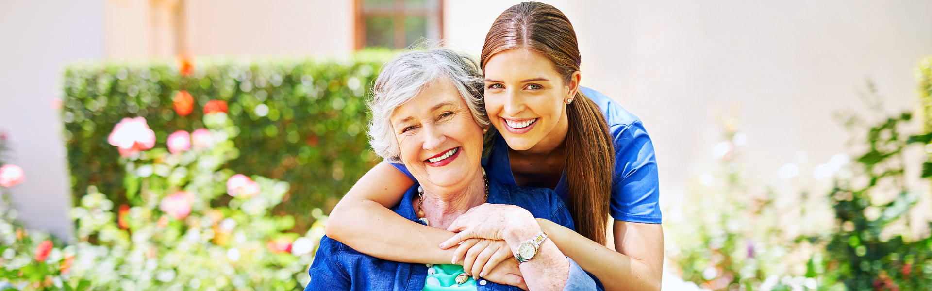 aide and elderly woman smiling